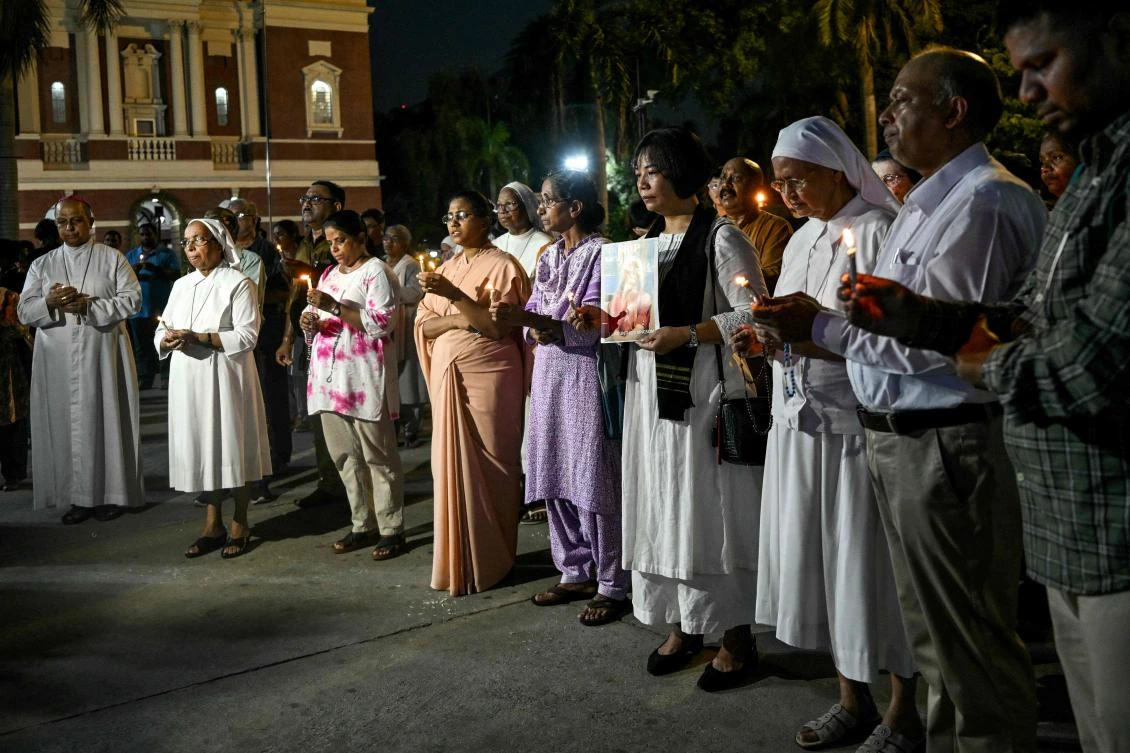 Members of the Christian community take part in a candlelight prayer service for the victims of the Ahmedabad flight crash, at Sacred Heart Cathedral in New Delhi, June 14, 2025. (AFP)