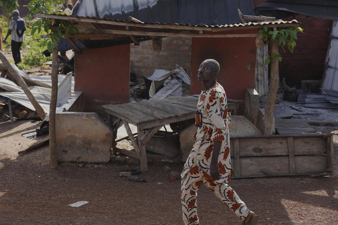 A man walks past a damaged house following an attack by gunmen in Yelewata community, north-central Nigeria, June 16, 2025. (AP)