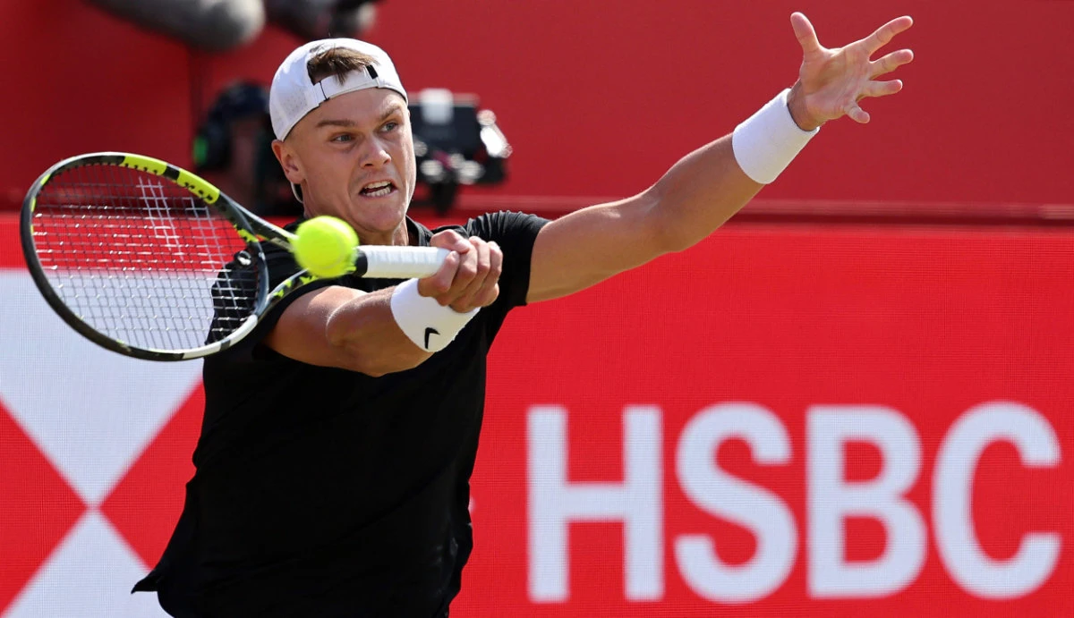 Denmark's Holger Rune returns against Australia's Christopher O'Connell during their men's singles round of 32 tennis match at the HSBC ATP tennis Championships at Queen's Club in west London on Monday. (AFP)