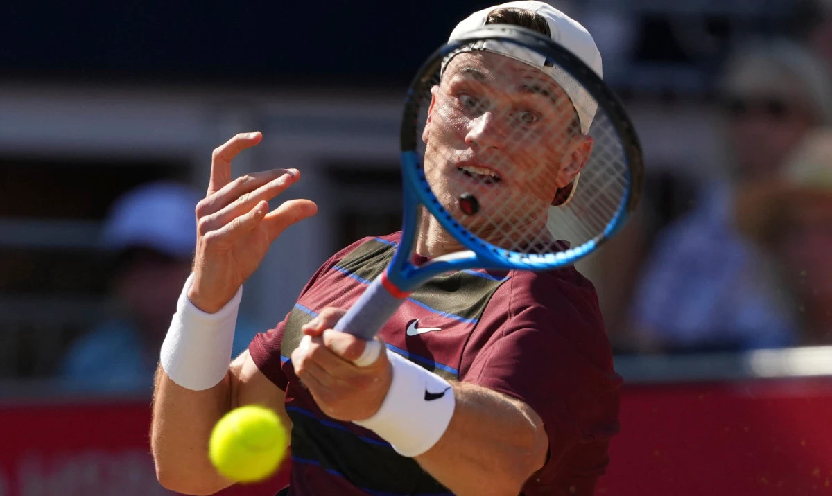Britain’s Jack Draper hits a return to Australia's Alexei Popyrin during their men’s singles match at the Queens Club grass court tennis championships in London Wednesday. (AP)