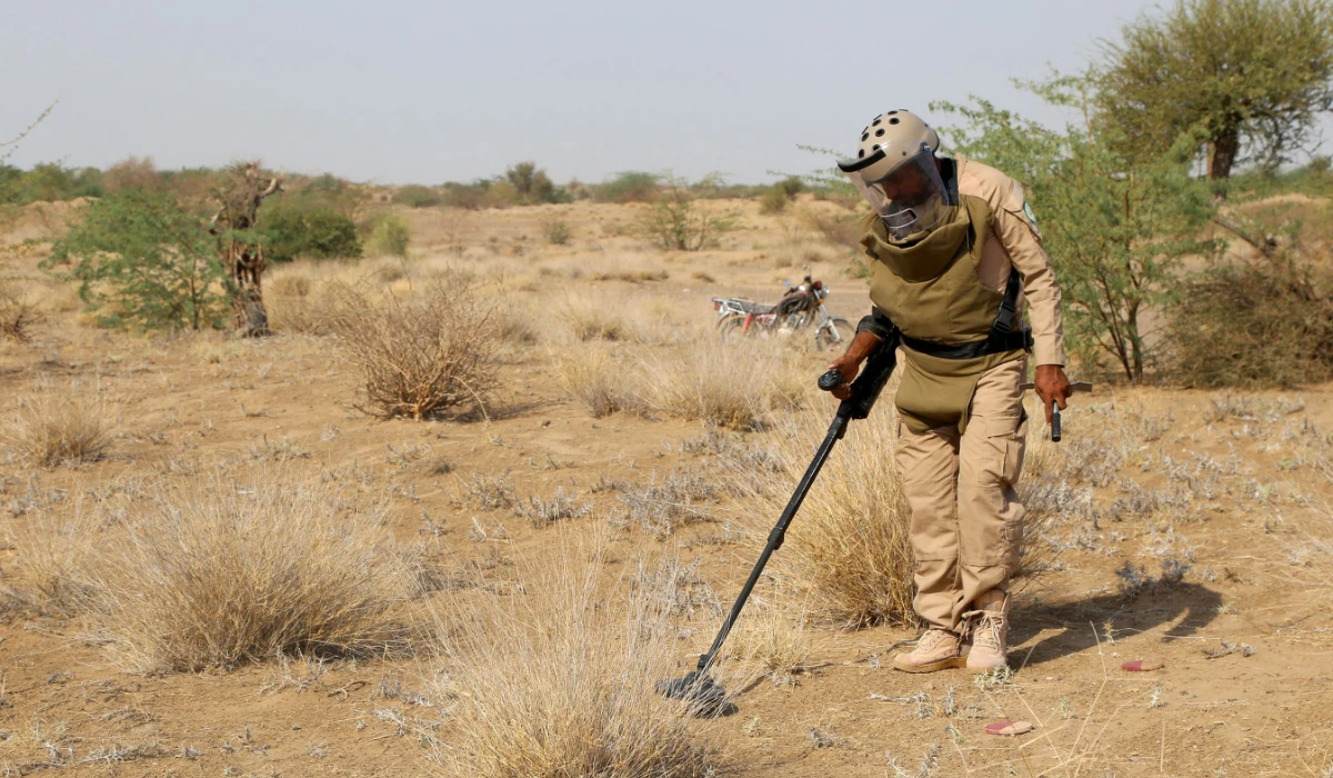 A member of Yemen's Saudi-backed pro-government forces searches for explosive devices in the village of Hays in Yemen's western province of Hodeida on August 11, 2023. (AFP)