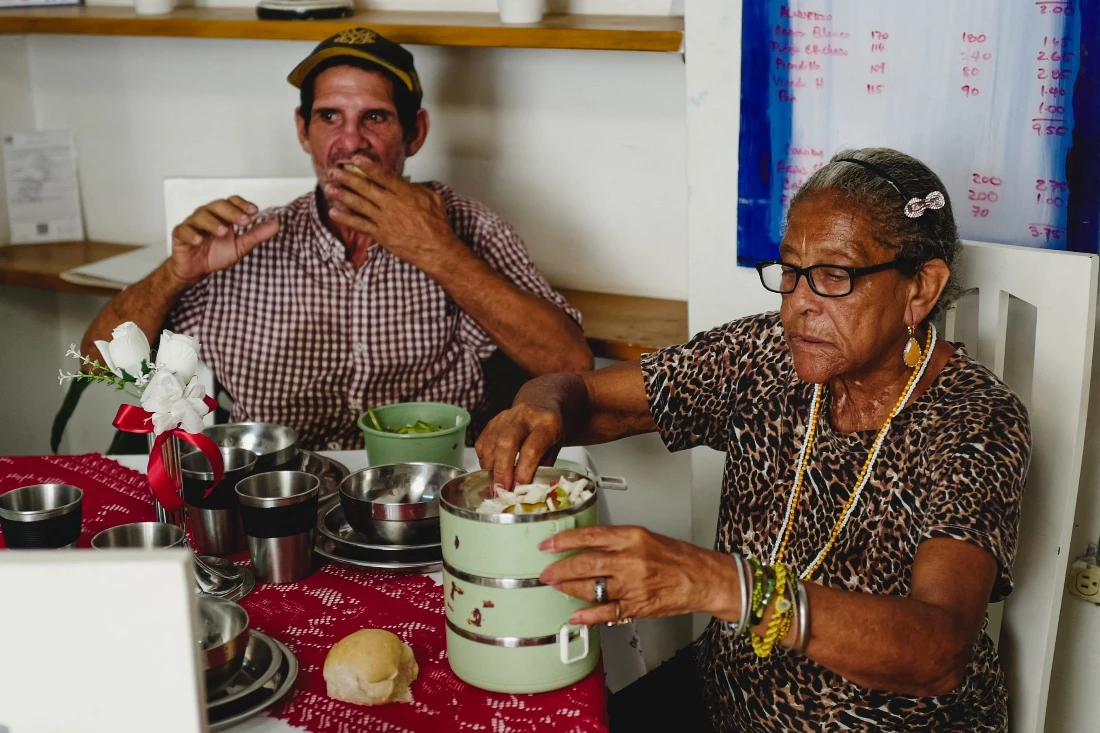 Senior citizens receive food at a public food center part of the Family Attention System in Havana, Cuba. (AFP)