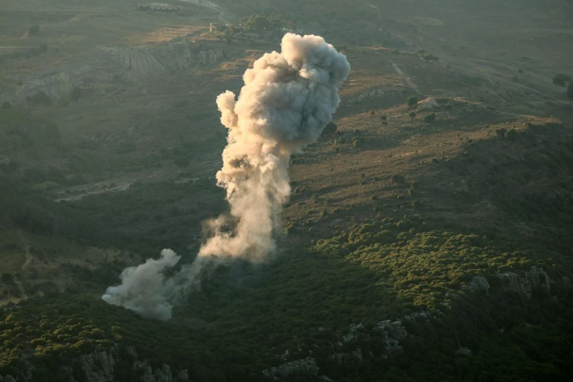 A plume of smoke rises above hills after an Israeli strike in the southern Lebanese Jezzine district on June 20, 2025. The Lebanese health ministry said an Israeli strike on south Lebanon killed one person on Juen 20, as Israel said it killed a member of Iran-backed militant group Hezbollah. (Photo by Rabih DAHER / AFP)