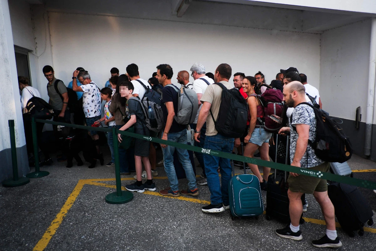 Citizens repatriated from Israel disembark a flight from Egypt at Figo Maduro airport in Lisbon on June 19, 2025. (AFP)