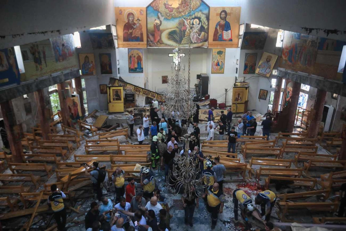 People and rescuers inspect the damage at the site of a reported suicide attack at the Saint Elias church in Damascus’ Dwelaa area on June 22, 2025. (AFP)