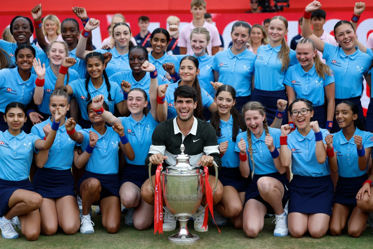 Spain’s Carlos Alcaraz celebrates with ball kids and the trophy. (Reuters)