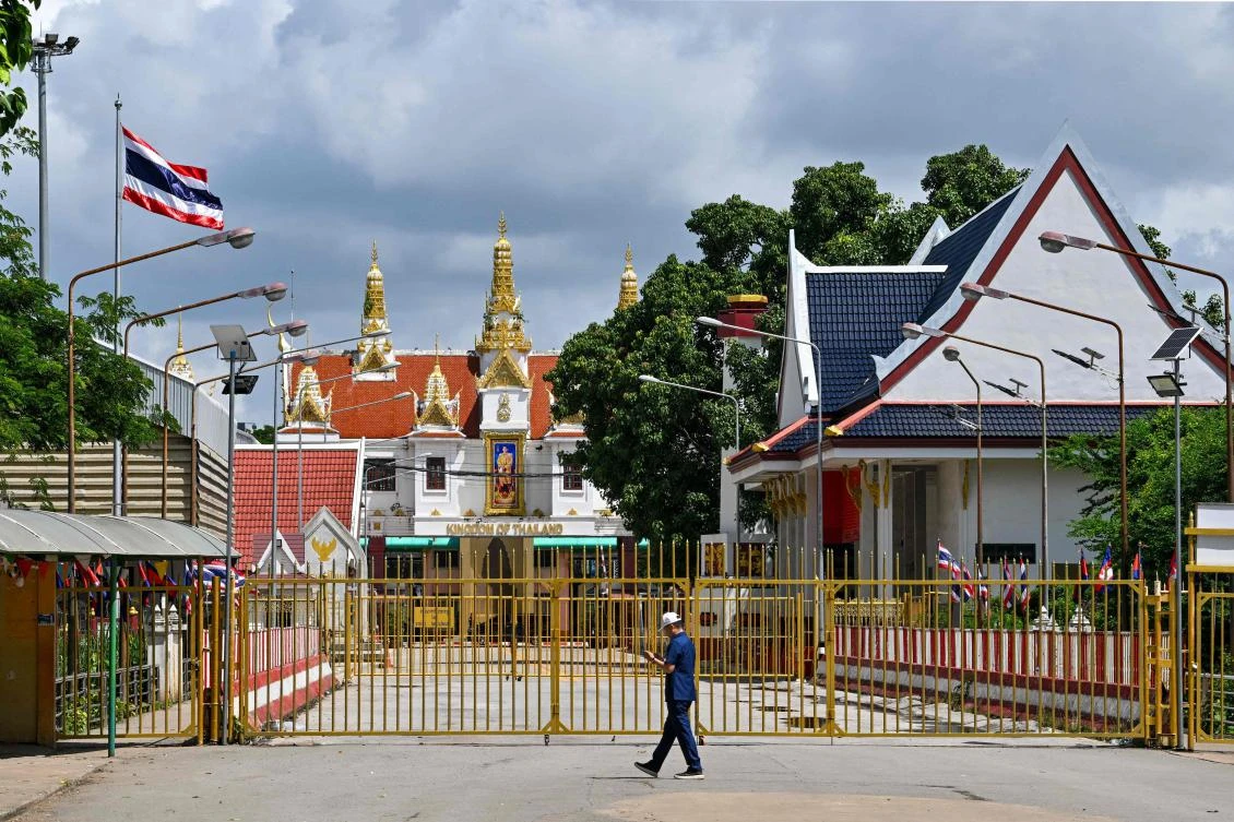 A man walks near the closed gate at Poipet International border checkpoint between Cambodia and Thailand, at Poipet town in Banteay Meanchey province on June 25, 2025. (AFP)