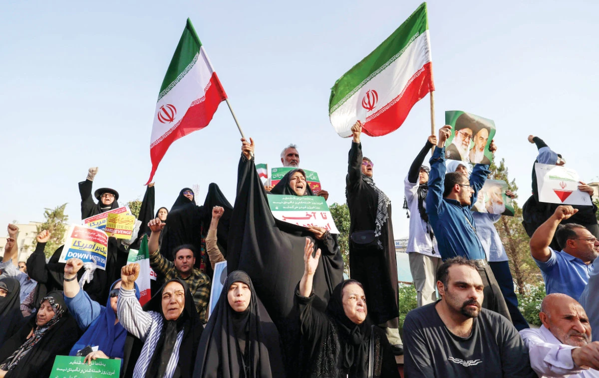 Iranians in Tehran wave national flags as they welcome a ceasefire between Iran and Israel. (AFP)