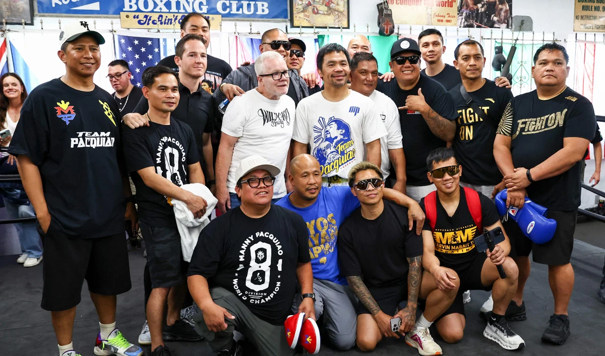Trainer Freddie Roach (center left) and Manny Pacquiao (center right) pose with their team at Wild Card Boxing Club on Wednesday in Los Angeles, California. (Getty Images via AFP)