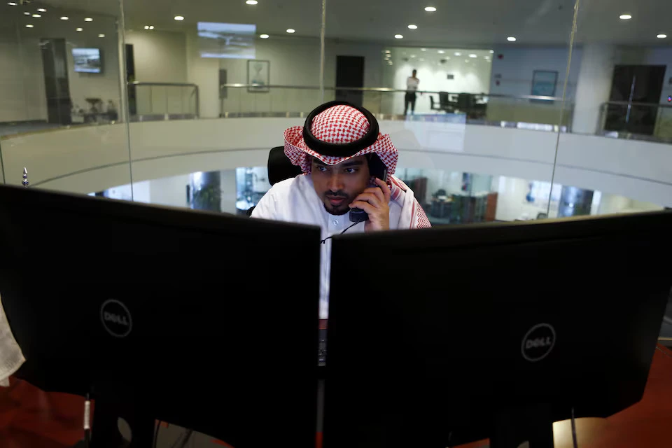 A Saudi trader observes the stock market on monitors at the Falcom stock exchange agency in Riyadh, Saudi Arabia. File/Reuters