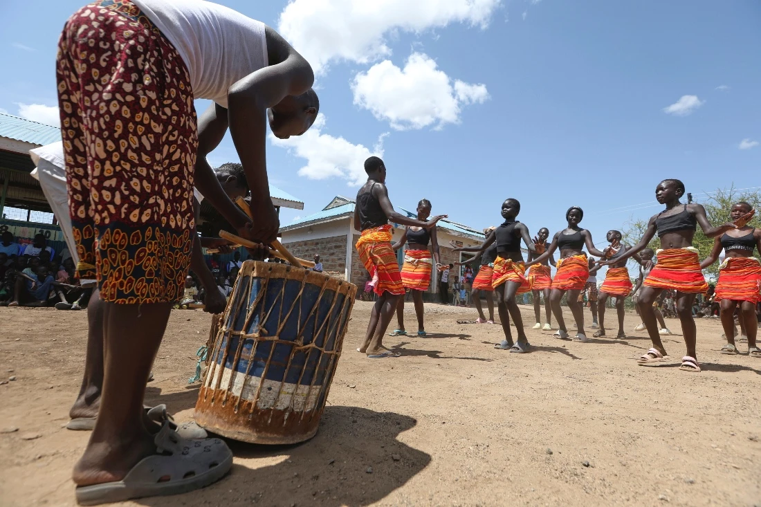 Refugee children from the Acholi Dancers group rehearse their traditional dance at a Child-Friendly Space within the Kalobeyei Refugee Settlement in Turkana, Kenya. (AP)