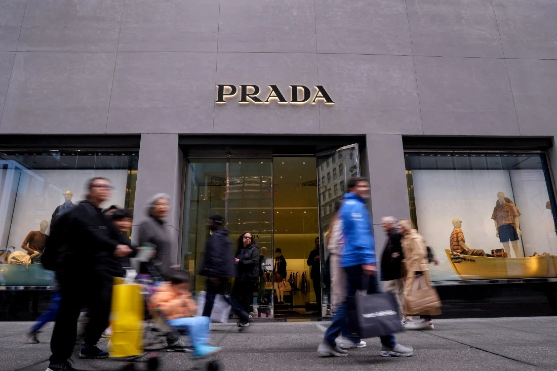 People walk by the luxury fashion house Prada store on 5th Avenue in New York City, US. (Reuters)