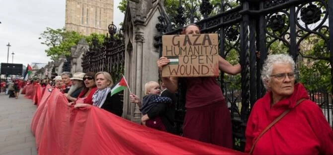 Protestors form a red line outside Houses of Parliament in London, UK. (AFP)