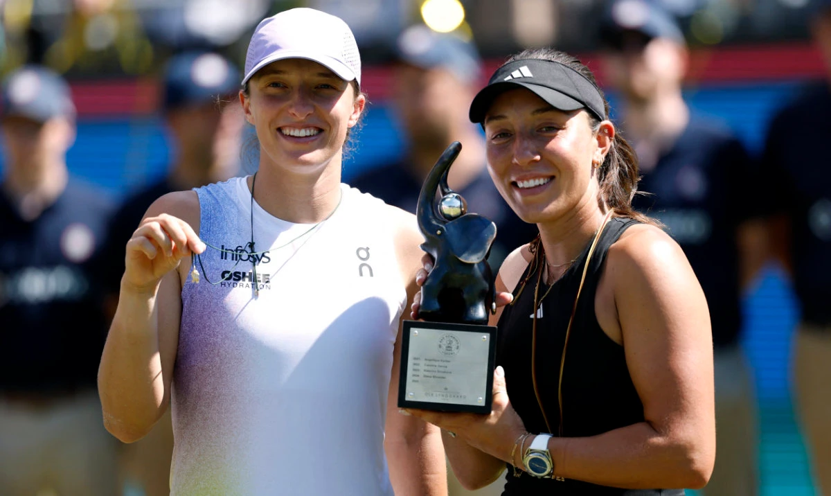 Jessica Pegula of the US celebrates with the trophy alongside Poland's Iga Swiatek after winning her women's singles final of Bad Homburg Open on Saturday. (Reuters)