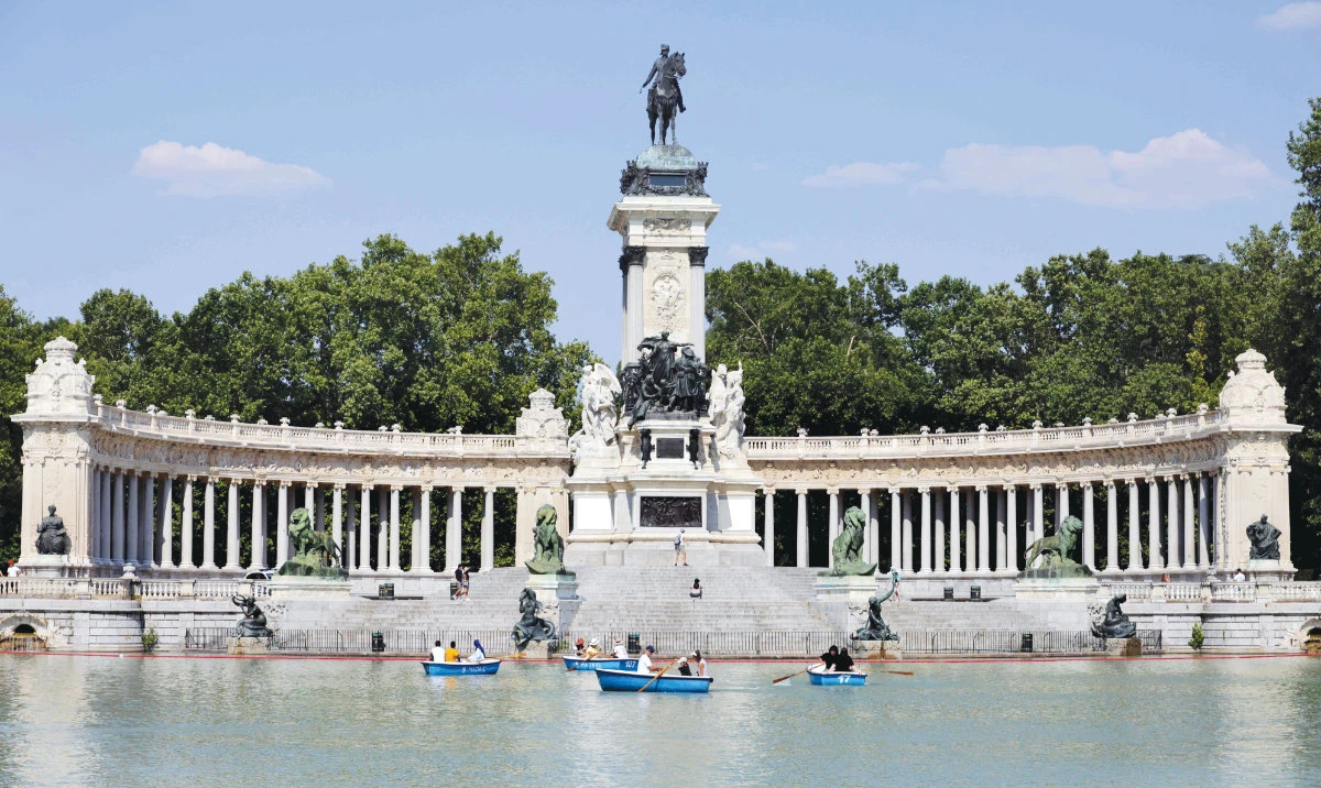 People sail on a lake in a park during the first heat wave of the summer in Madrid on Saturday. Southern Europe is again facing extreme temperatures exceeding 40 C. (AFP)