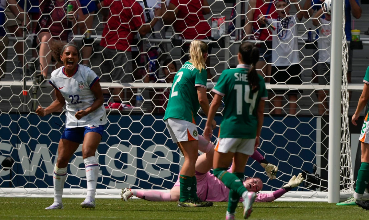 US forward Yazmeen Ryan celebrates after scoring as Ireland defender Jessie Stapleton (2) and goalkeeper Courtney Brosnan, bottom right, defend during the second half of an international friendly women’s soccer match in Cincinnati Sunday. (AP)
