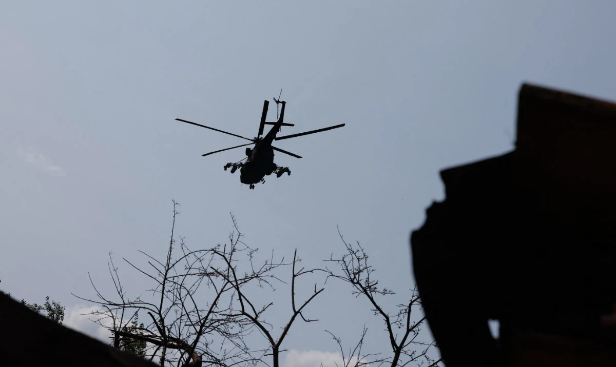 A Russian military helicopter flies in the sky, in the course of Russia-Ukraine conflict in the Donetsk Region. (Reuters)
