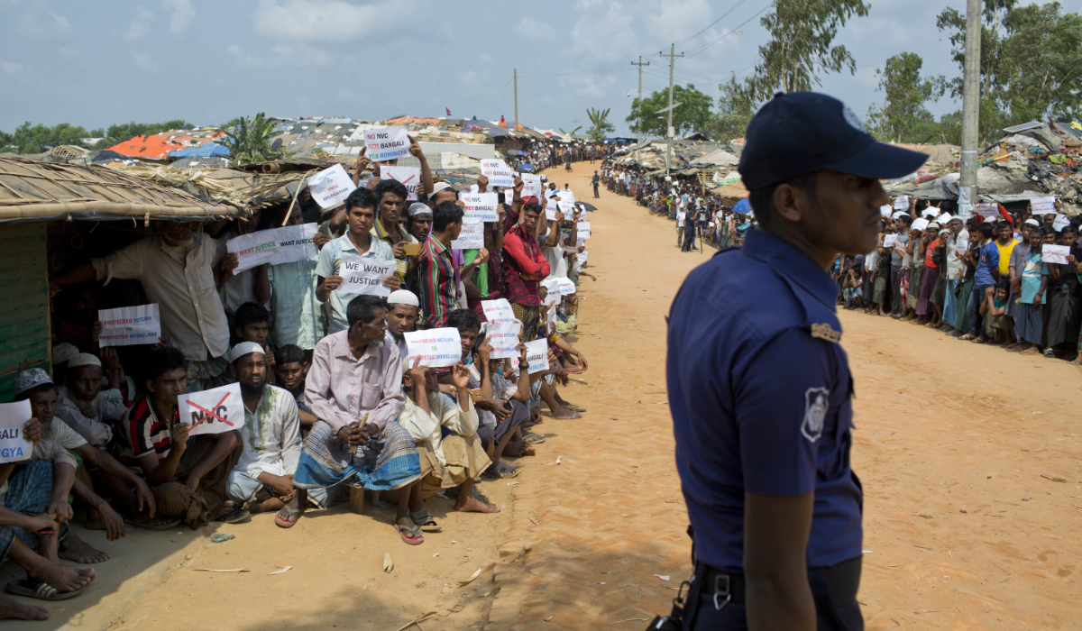 Rohingya refugees holing placards, await the arrival of a UN Security Council team at a refugee camp in Bangladesh. (AP)