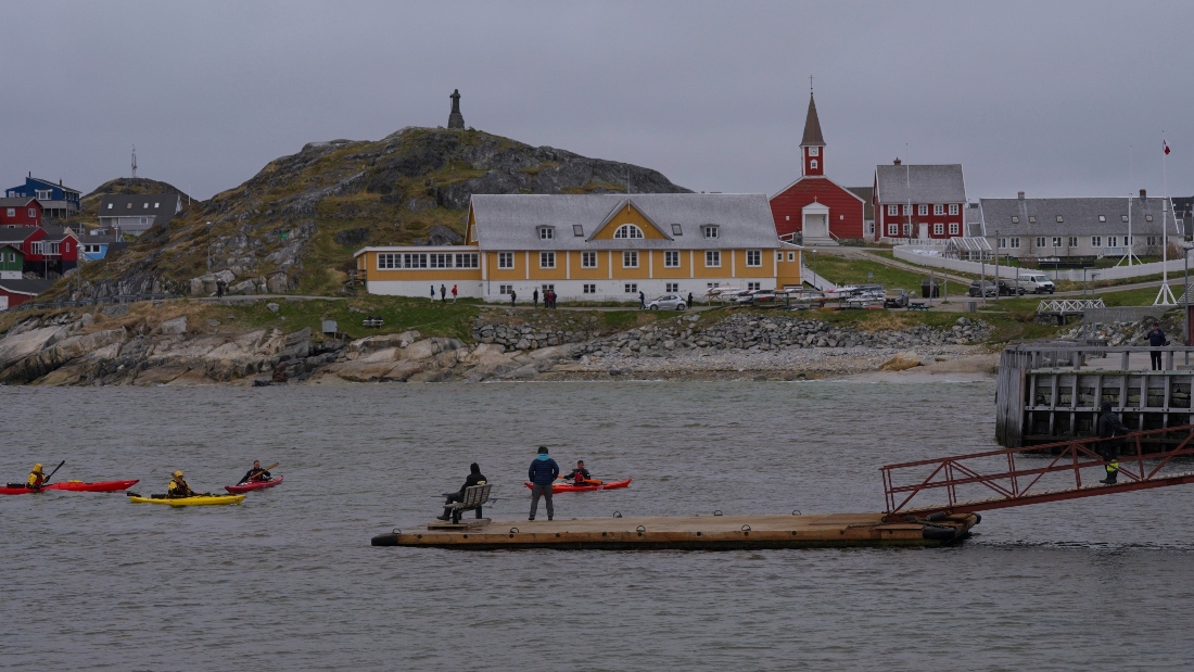Tourists kayak at sea in front of Nuuk Cathedral in Greenland. (AP)
