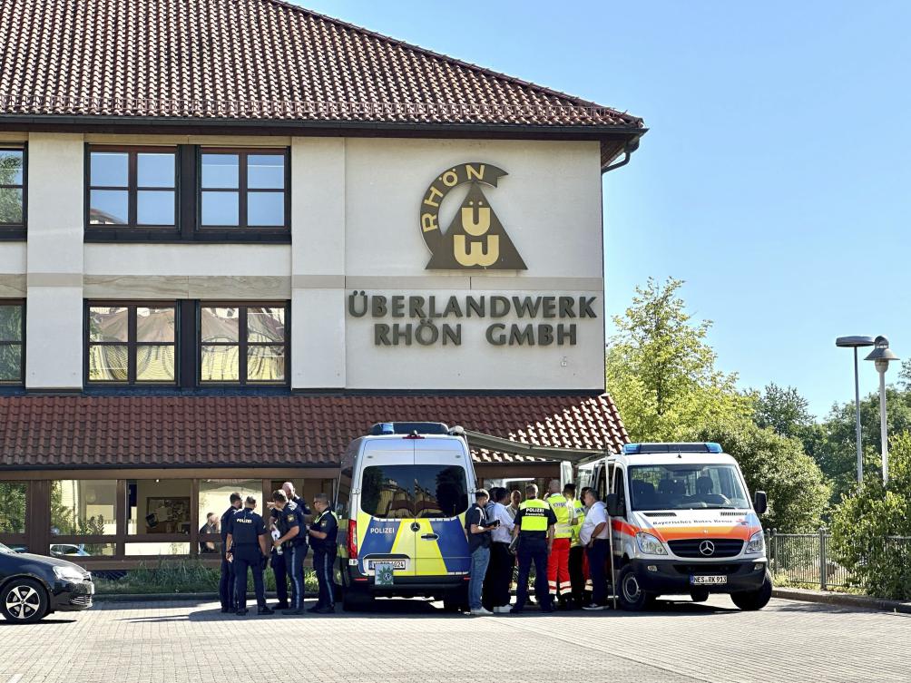 Police and emergency services stand on the premises of regional grid operator Überlandwerk Rhön, after a man armed with a sharp object attacked people at a company in Germany, killing at least one, police said, in Mellrichstadt, Germany, Tuesday July 1, 2025. (AP)