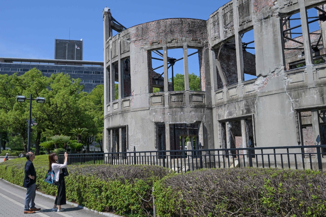 Visitors take a photo of the Atomic Bomb Dome in the centre of Hiroshima, Japan. (AFP)
