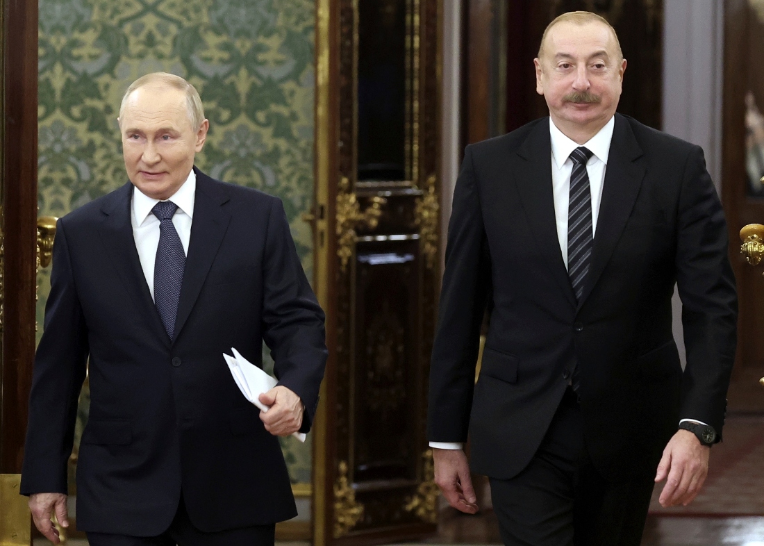 Russian President Vladimir Putin and Azerbaijani President Ilham Aliyev enter a hall during a meeting at the Kremlin in Moscow, Russia. (AP)