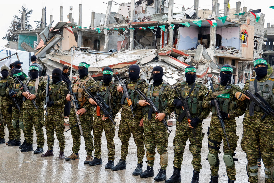 Palestinian Hamas militants stand guard on the day of the handover of hostages held in Gaza since the deadly October 7 2023 attack, as part of a ceasefire and a hostages-prisoners swap deal between Hamas and Israel, in Rafah in the southern Gaza Strip, February 22, 2025. (Reuters)