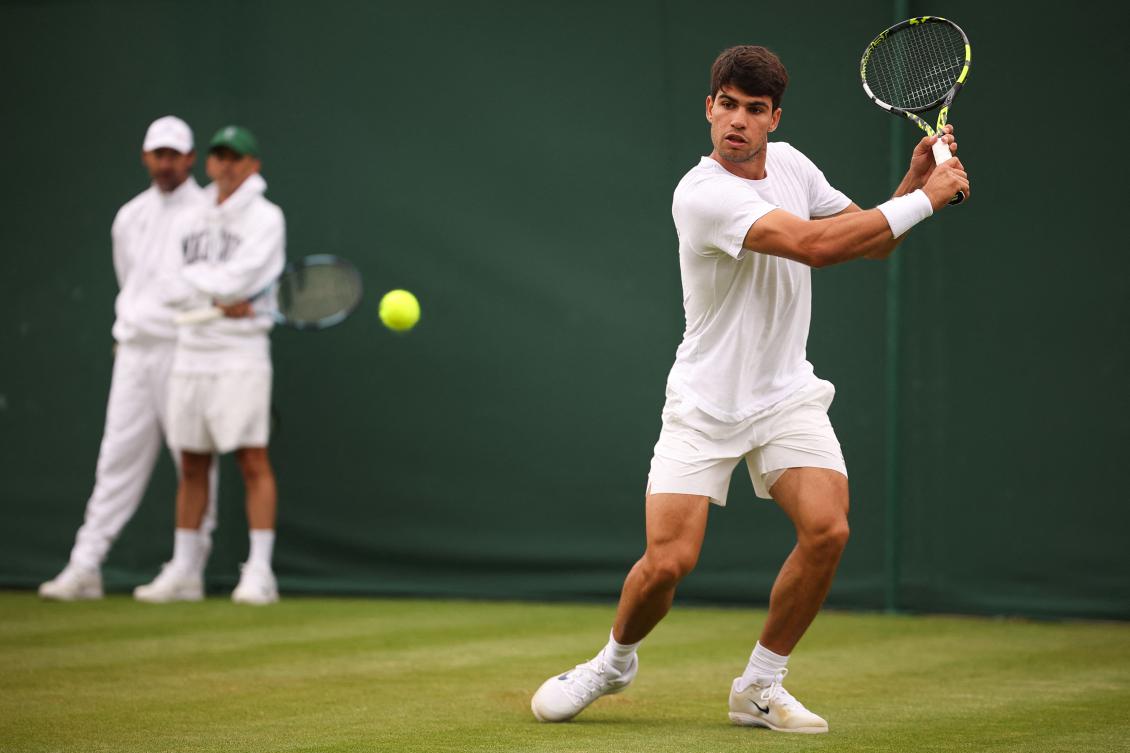 Spain’s Carlos Alcaraz trains in front of his coaches on court 7 ahead of his men’s singles second round tennis match against Britain’s Oliver Tarvet on the third day of the 2025 Wimbledon Championships at The All England Lawn Tennis and Croquet Club in Wimbledon, on July 2, 2025. (AFP)