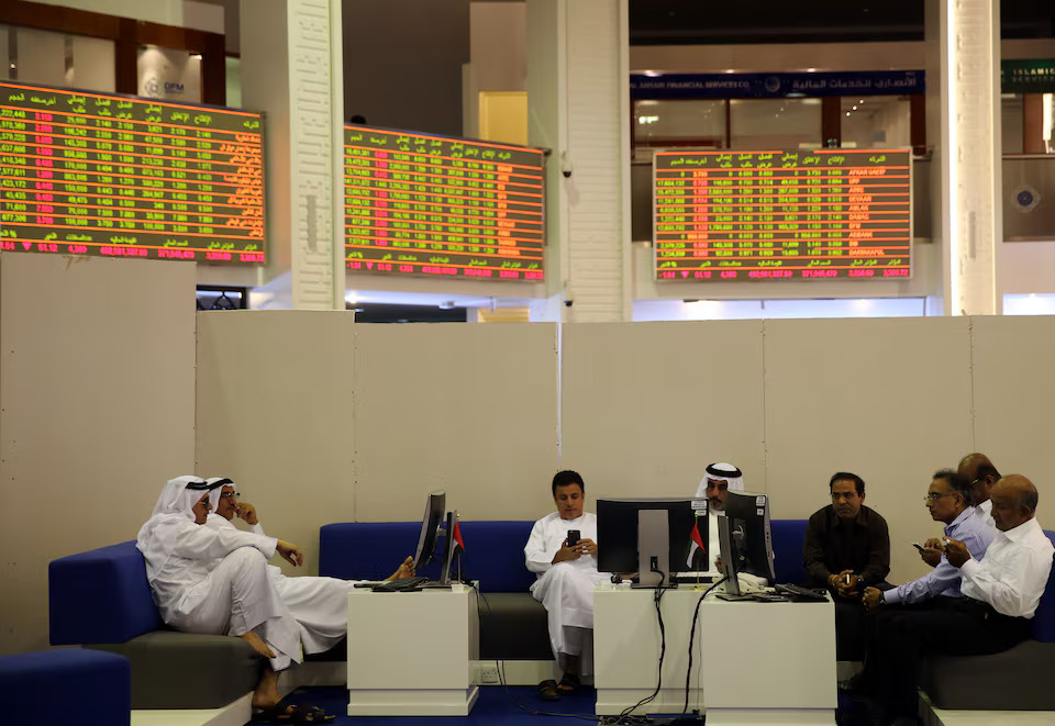 Traders monitor stock information at Dubai Financial Market, in Dubai, UAE. File/Reuters
