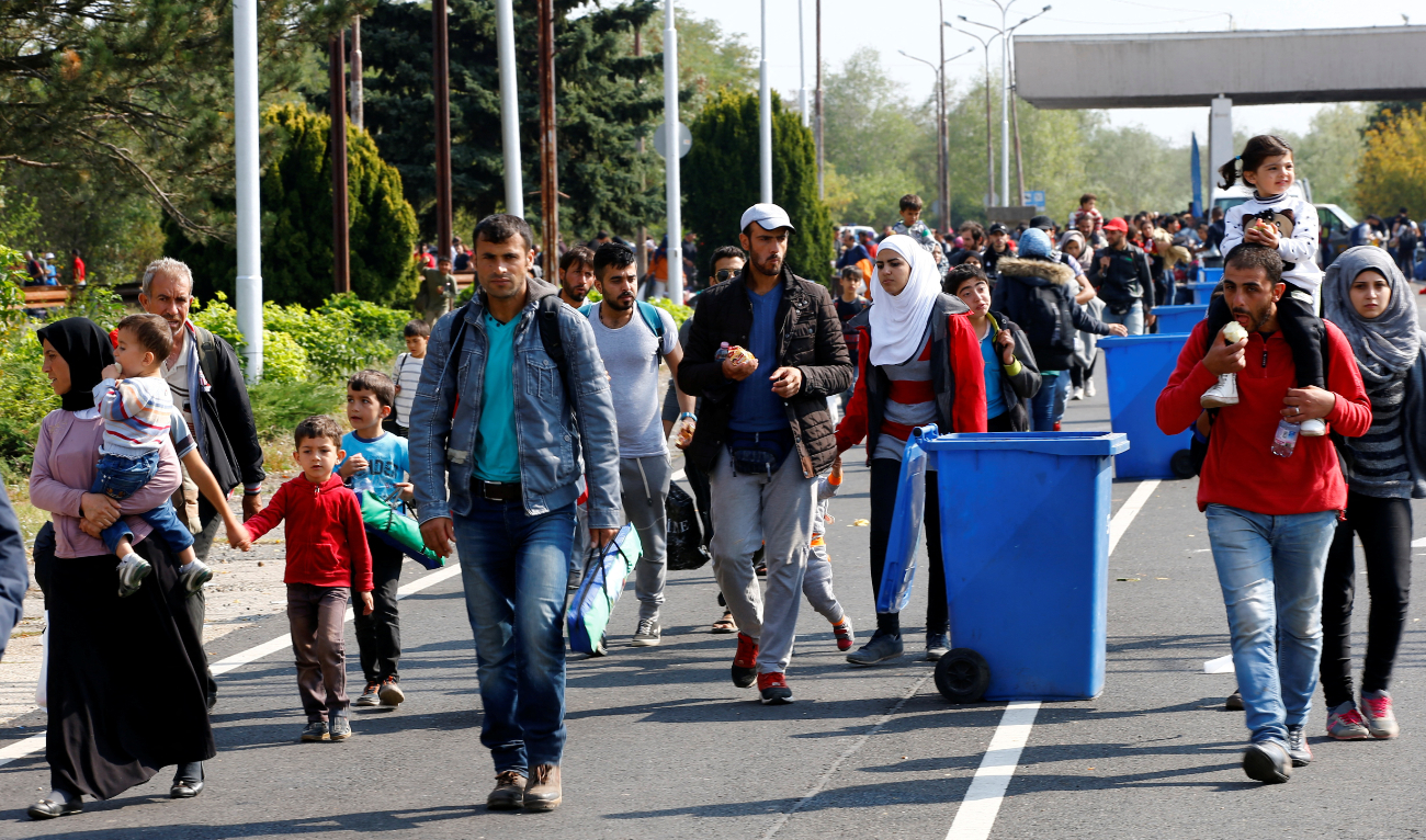 Migrants pass by garbage bins as they walk towards the Austrian border from Hegyeshalom, Hungary , September 23, 2015. (Reuters/File)