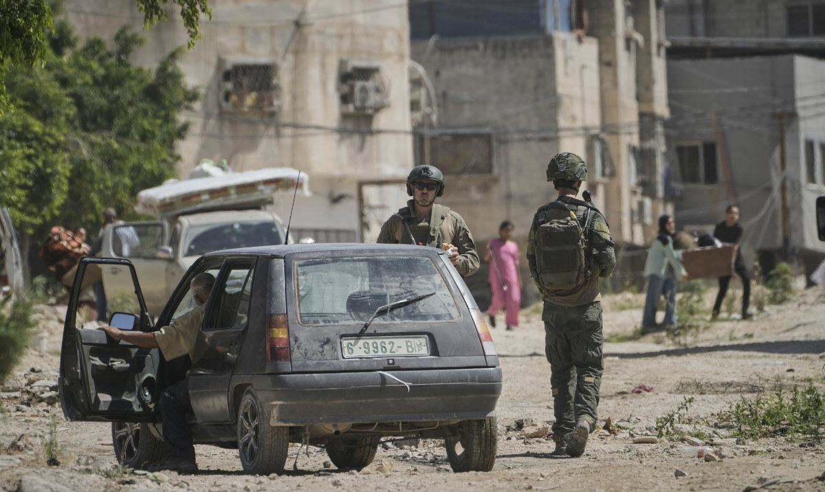 Palestinians gather their belongings as Israeli forces prepare to demolish homes in the Tulkarem refugee camp in the West Bank, Wednesday, July 2, 2025. (AP)