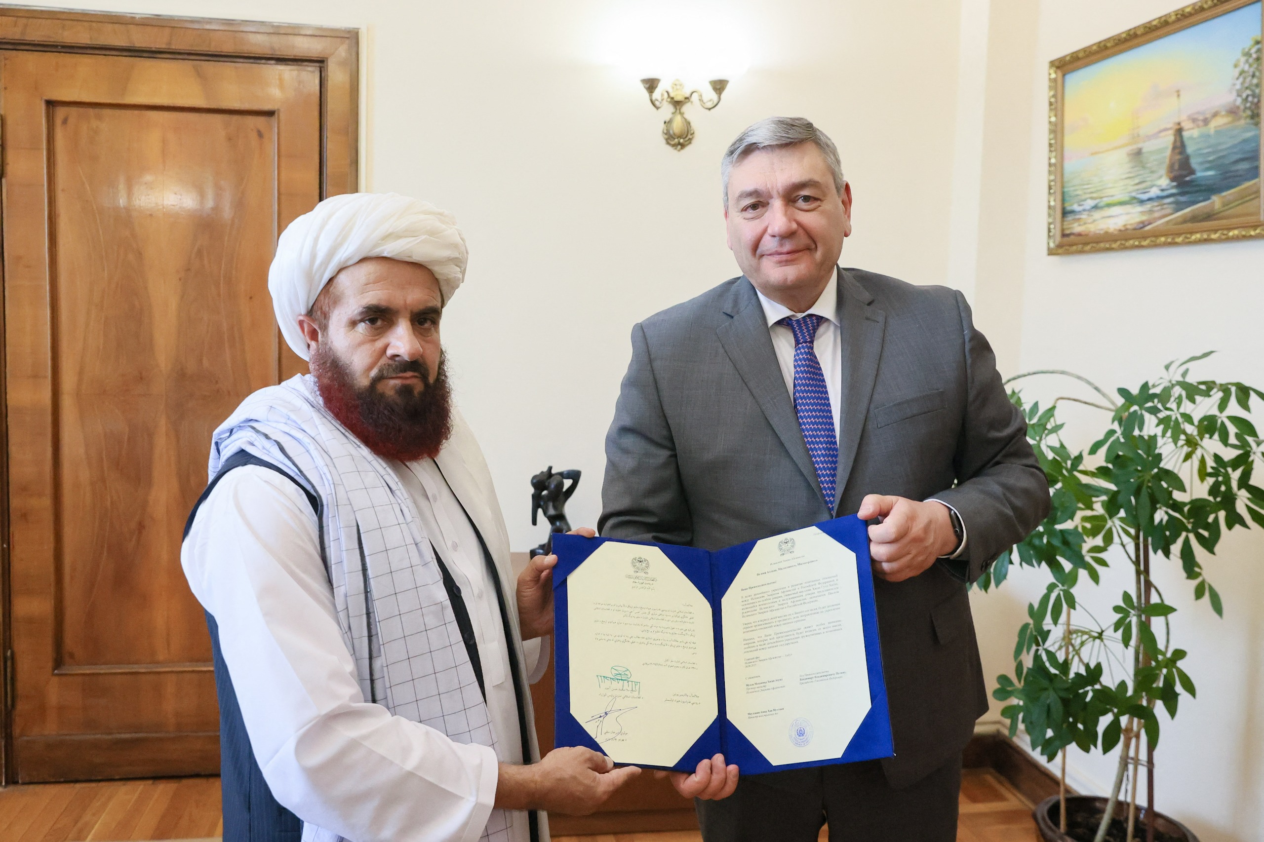 In this handout photo released by the Russian Foreign Ministry on July 3, 2025, the newly appointed Taliban envoy to Moscow, Gul Hassan, hands his credence letters to the Deputy Foreign Minister Andrei Rudenko in Moscow. (AFP/Russian Foreign Ministry/File)