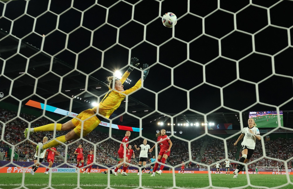 Germany’s Jule Brand, right,scores their first goal past Poland’s goalkeeper Kinga Szemik during the Women’s Euro 2025 Group C match against Poland on Friday. (Reuters)