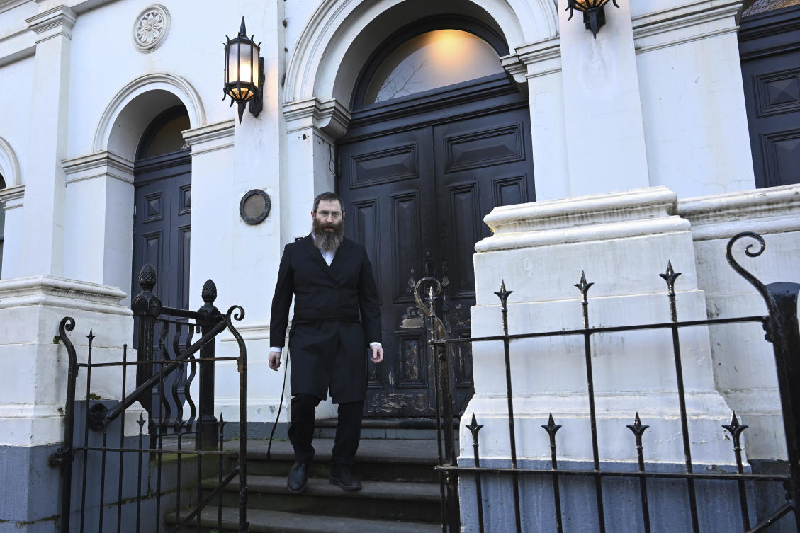 Rabbi Dovid Gutnick walks past damage to the exterior of the East Melbourne Hebrew Congregation in Melbourne, Saturday, July 5, 2025. (AAP Image via AP)