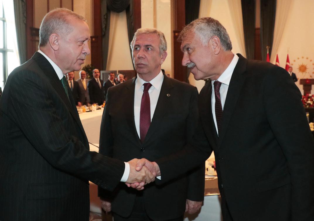 This handout photo taken and released by the Turkish Presidential Press Service on September 11, 2019 shows Turkey's President Recep Tayyip Erdogan (L) greeting Zeydan Karalar (R), Andana's Mayor of Turkey's secular opposition Republican People's Party CHP, next to Ankara's Mayor Mansur Yavas (CHP) (C) before a meeting in Ankara. (AFP)