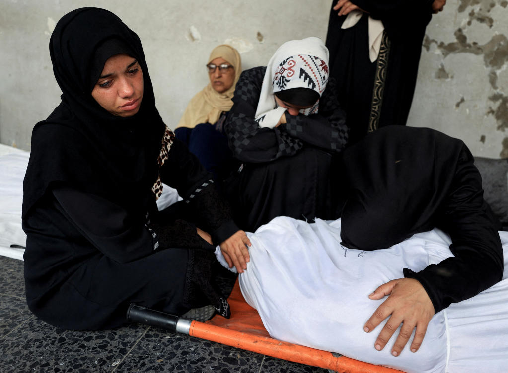 The latest strikes came hours after Hamas said it was ready to start talks ‘immediately’ on a US-sponsored proposal for a Gaza ceasefire. Above, a mourner reacts over a body at the funeral of Palestinians killed in an overnight Israeli air strike on July 5, 2025. (Reuters)