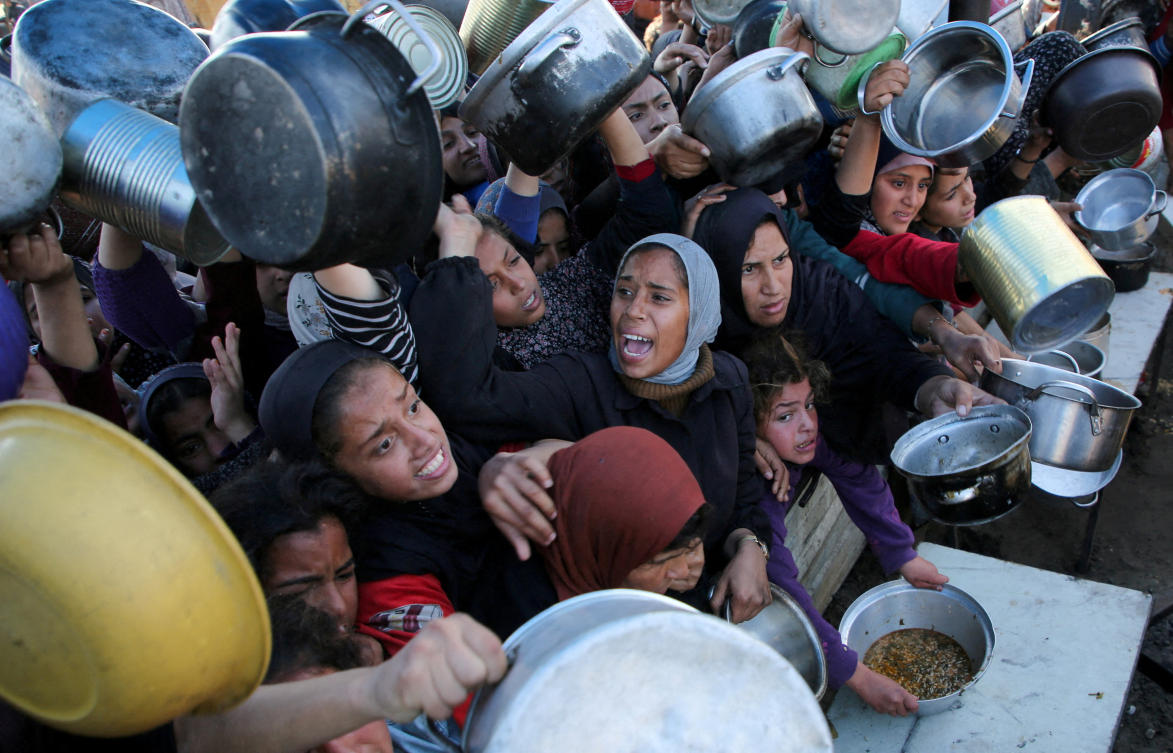 FILE PHOTO: Palestinians gather to receive food cooked by a charity kitchen, amid a hunger crisis, as the Israel-Hamas conflict continues, in Khan Younis in the southern Gaza Strip, January 2, 2025. (Reuters)