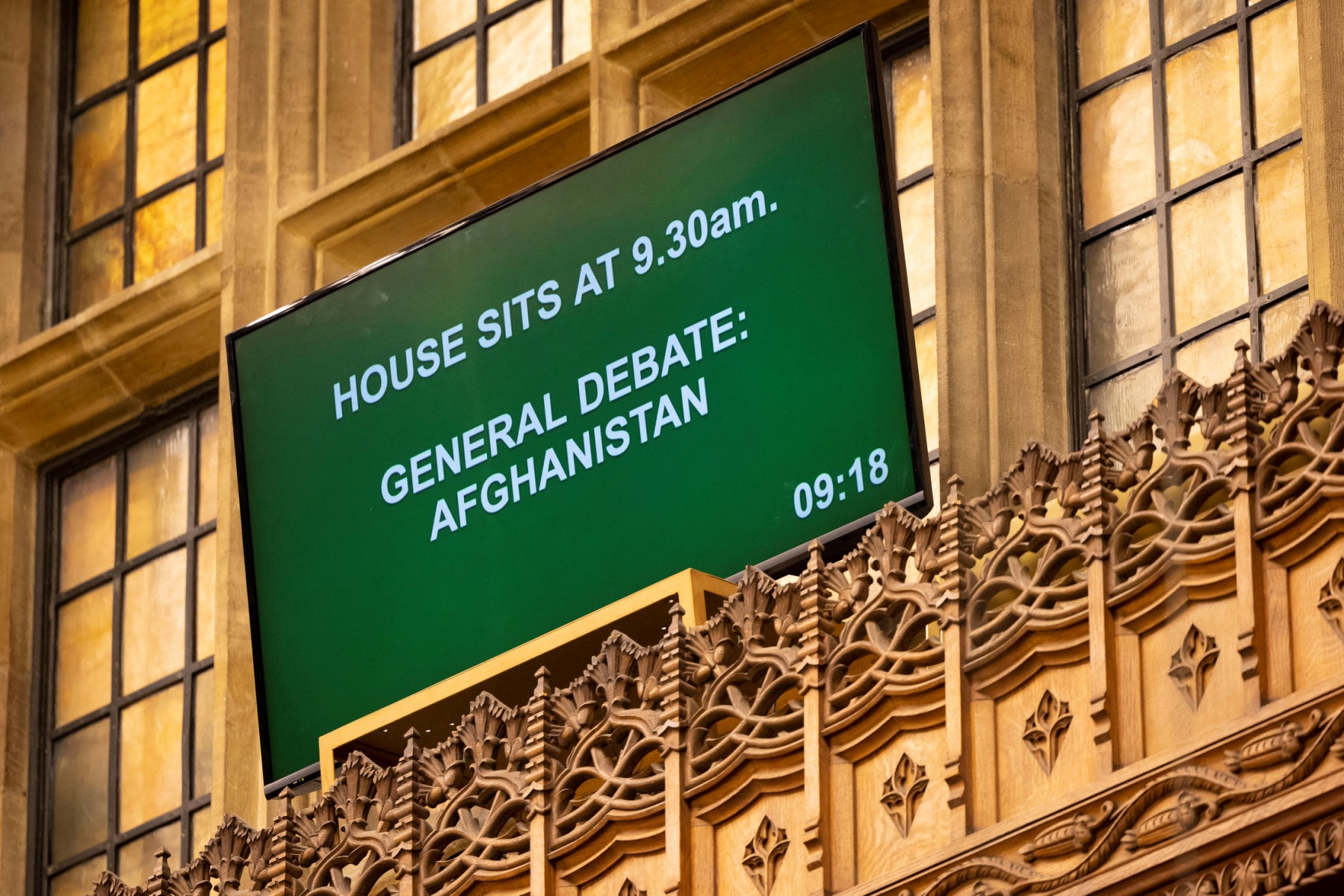 A handout photograph released by the UK Parliament shows signage displaying the session during an extraordinary session of parliament called to discuss the collapse of the Afghan government, in the House of Commons in London on August 18, 2021. (AFP/File Photo)