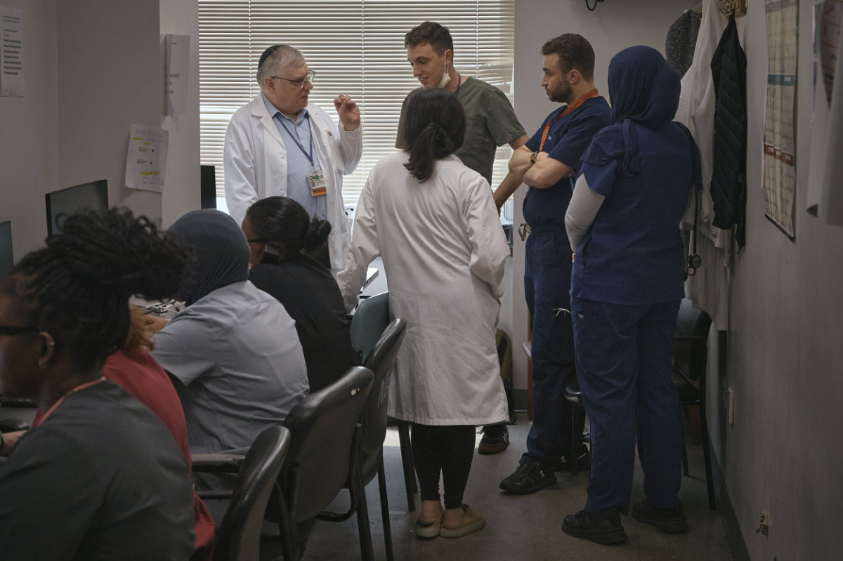 A group of resident doctors talks with a senior doctor inside Brookdale University Hospital and Medical Center on July 1, 2025, in the Brooklyn borough of New York. (AP Photo/Andres Kudacki)