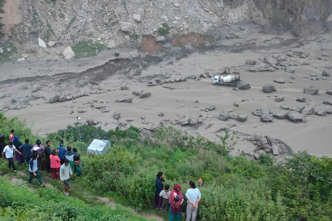 People look on the damage caused by flooding on the Bhotekoshi River 120 km north of Kathmandu, Nepal. (AP)