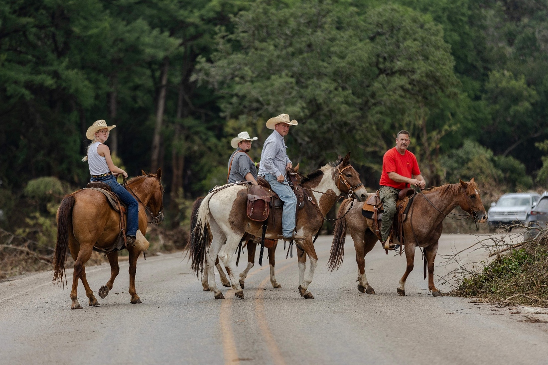 Search and rescue workers on horseback looking for survivors or the remains of victims swept up in the flash flooding on July 7, 2025 in Texas, US. (AFP)