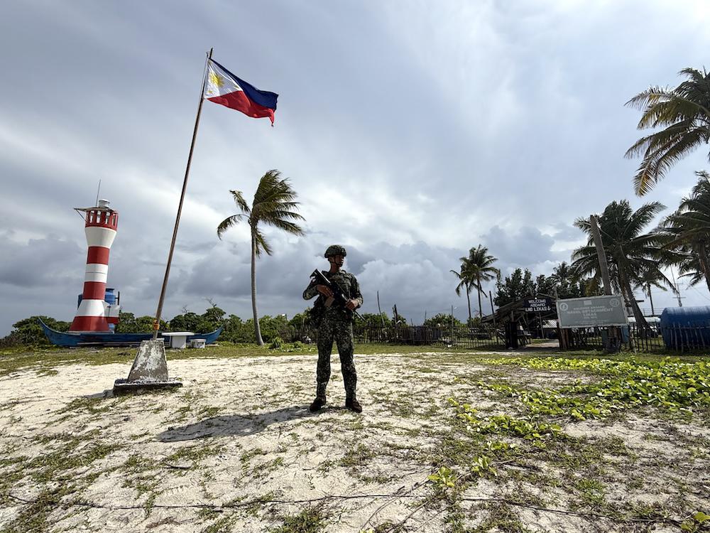 A marine soldier stands guard at Likas Island, one of the islands occupied by the Philippines in the disputed South China Sea on June 5, 2025, during a routine maritime patrol. (AFP)
