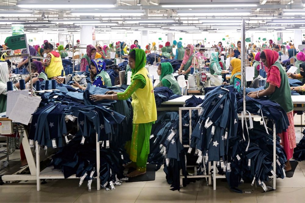 Bangladeshi garment workers tailor clothes at their sewing stations in a factory in Tongi, on the outskirts of Dhaka on July 6, 2025. (AFP)