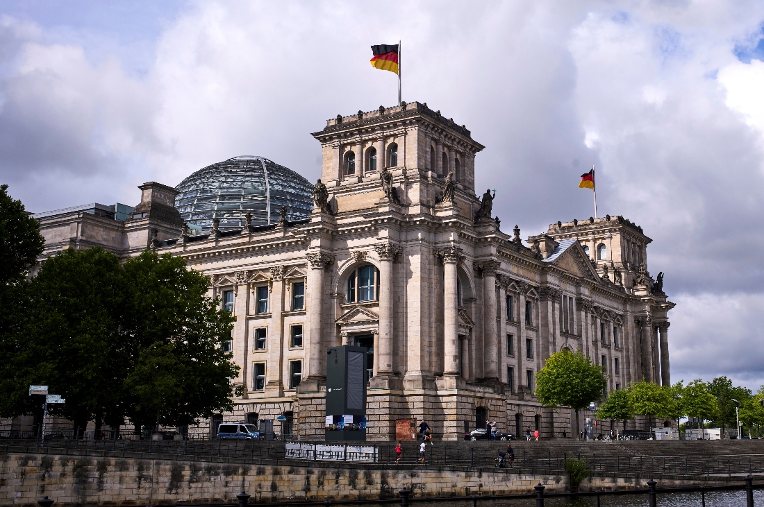 German national flags wave on top of the Reichstag Building, the house of the German parliament in Berlin, Germany. (AP)