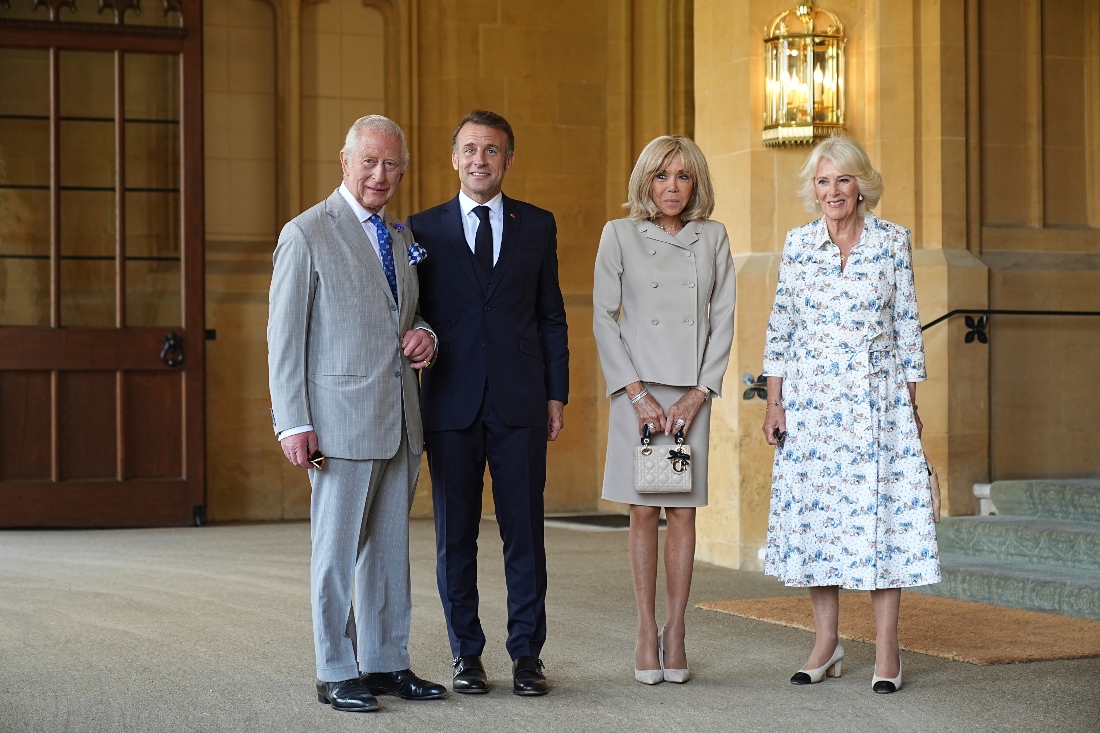 Britain's King Charles, French President Emmanuel Macron, his wife Brigitte Macron, and Britain's Queen Camilla, pose for a photo outside Windsor Castle in Berkshire, UK. (AP)