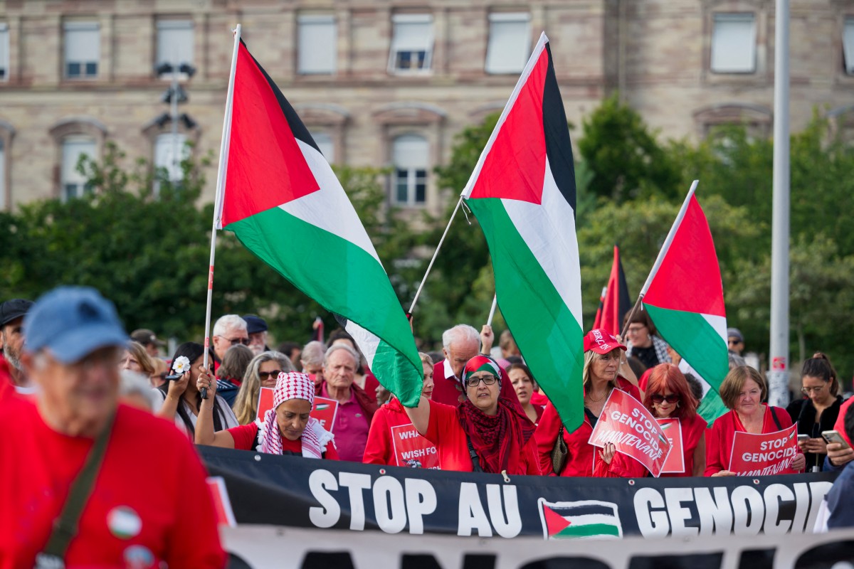Demonstrators hold Palestinian flags during a protest organized by non-governmental organizations, including Amnesty International, in Strasbourg, eastern France, July 8, 2025. (AFP)
