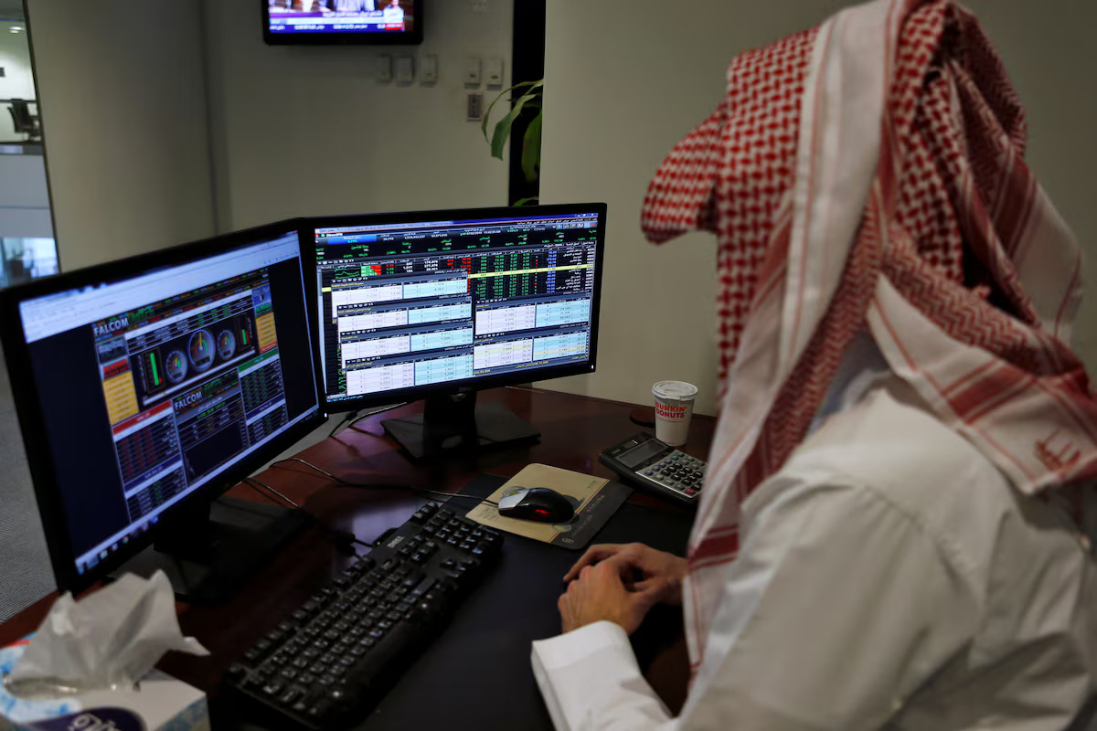 A Saudi trader observes the stock market on monitors at the Falcom stock exchange agency in Riyadh, Saudi Arabia. File/Reuters