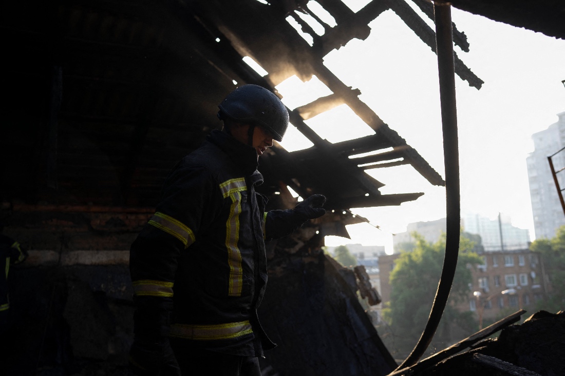 A firefighter stands in a damaged residential building following a major overnight Russian attack in Kyiv, Ukraine. (AFP)