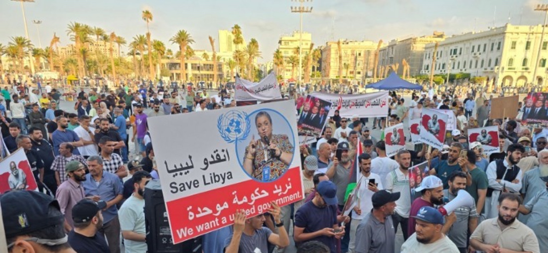Protestors raise placards as they demonstrate against the Government of National Unity, in Tripoli, Libya. (AFP)