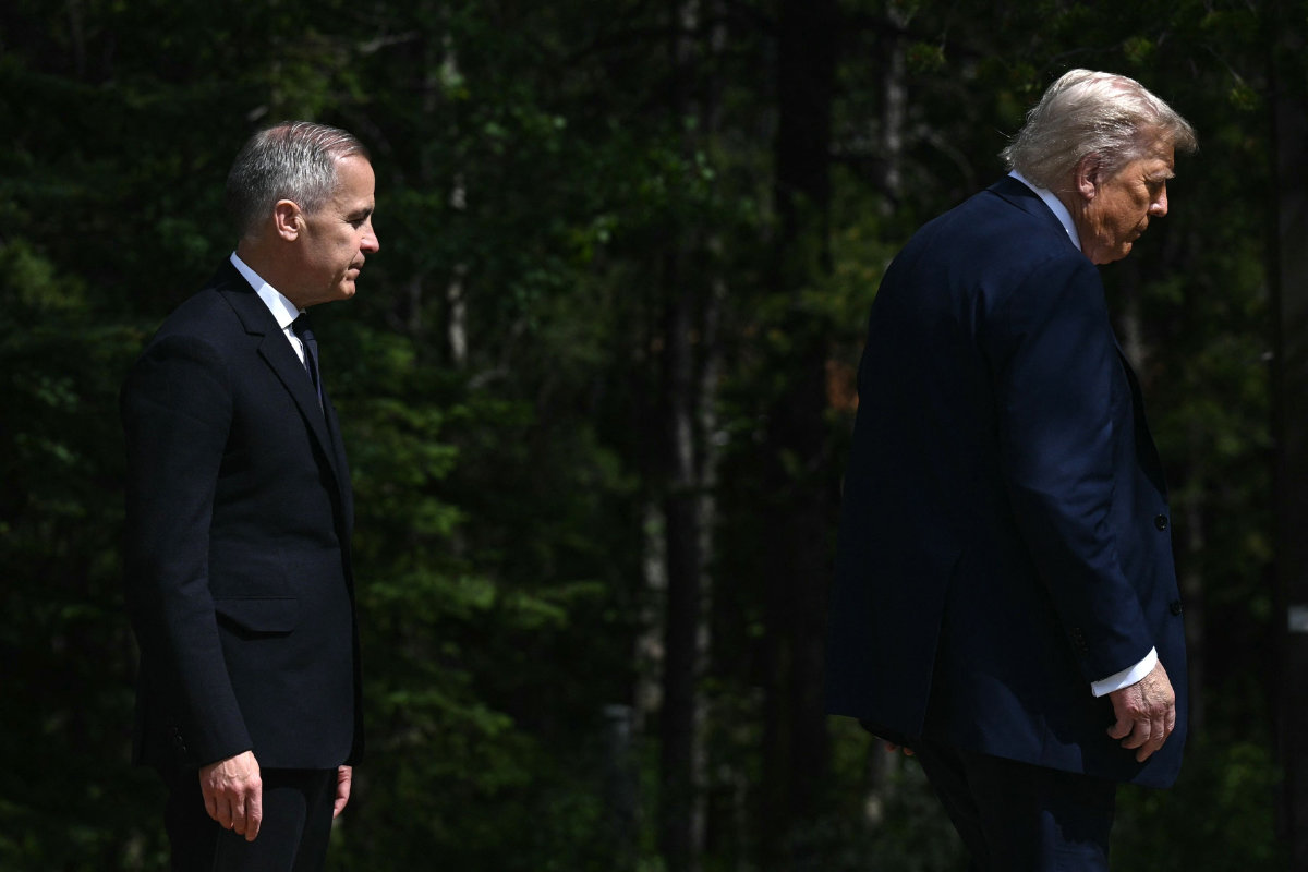 This photo taken on June 16, 2025 shows Canadian Prime Minister Mark Carney (L) welcoming US President Donald Trump during an arrival ceremony at the Group of Seven (G7) Summit at the Pomeroy Kananaskis Mountain Lodge in Kananaskis, Alberta, Canada. (AFP)